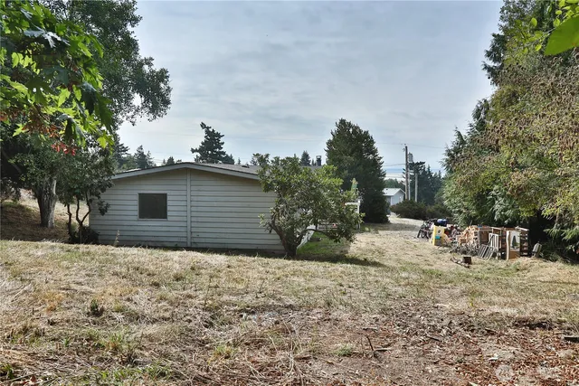 a backyard of a house with table and chairs
