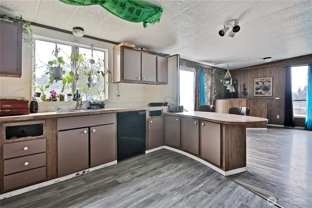 a kitchen with a sink window and cabinets