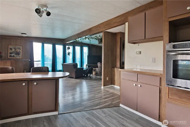 a kitchen with counter top space a sink cabinets and appliances