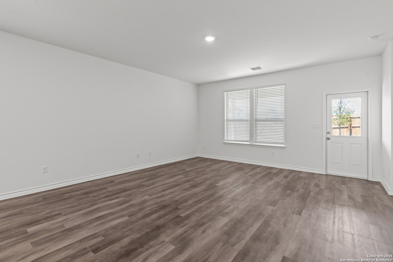 4141 Bermuda Lane Seguin, TX 78155 - Photo 11 of 28 an empty room with wooden floor and windows