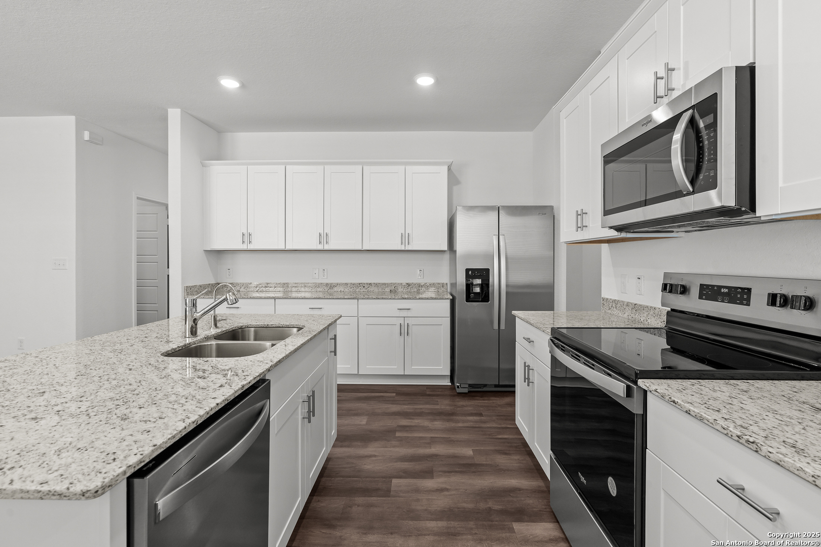 4141 Bermuda Lane Seguin, TX 78155 - Photo 4 of 28 a kitchen with stainless steel appliances granite countertop a sink stove microwave and refrigerator