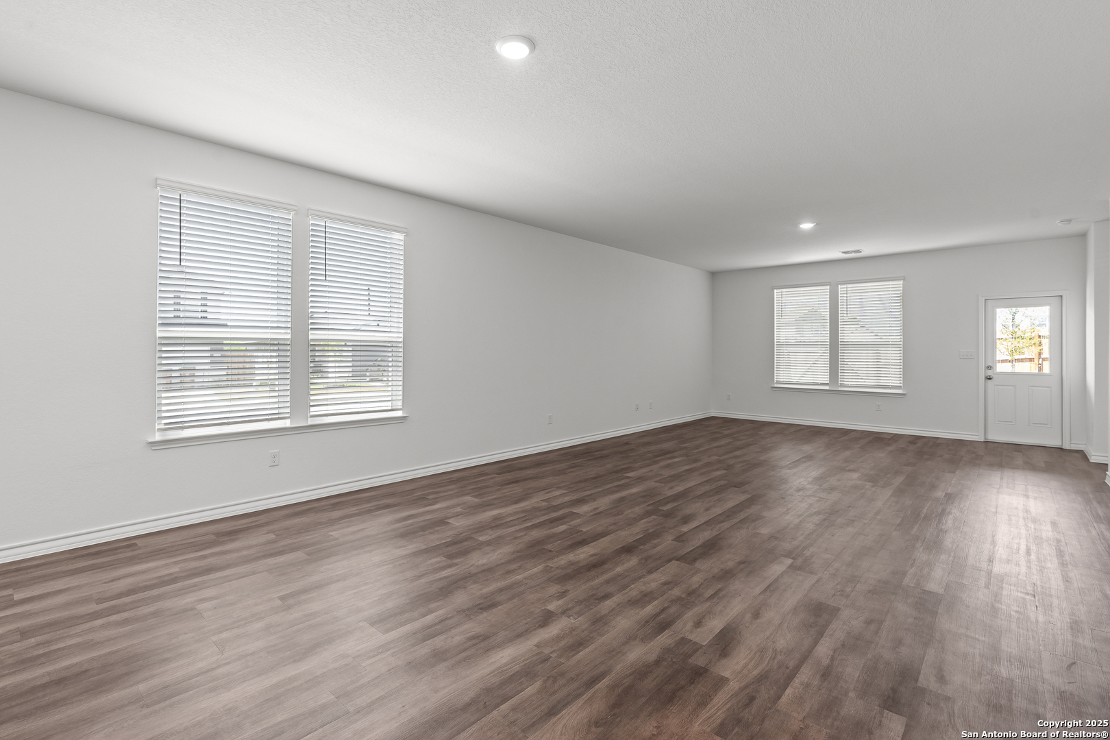 4141 Bermuda Lane Seguin, TX 78155 - Photo 7 of 28 an empty room with wooden floor and windows