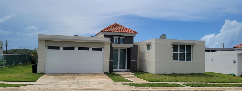 Paisaje Del Rio Paisaje Del Rio Via, Unit C9 Luquillo, PR 00773 - Photo 1 of 1 a front view of a house with a yard