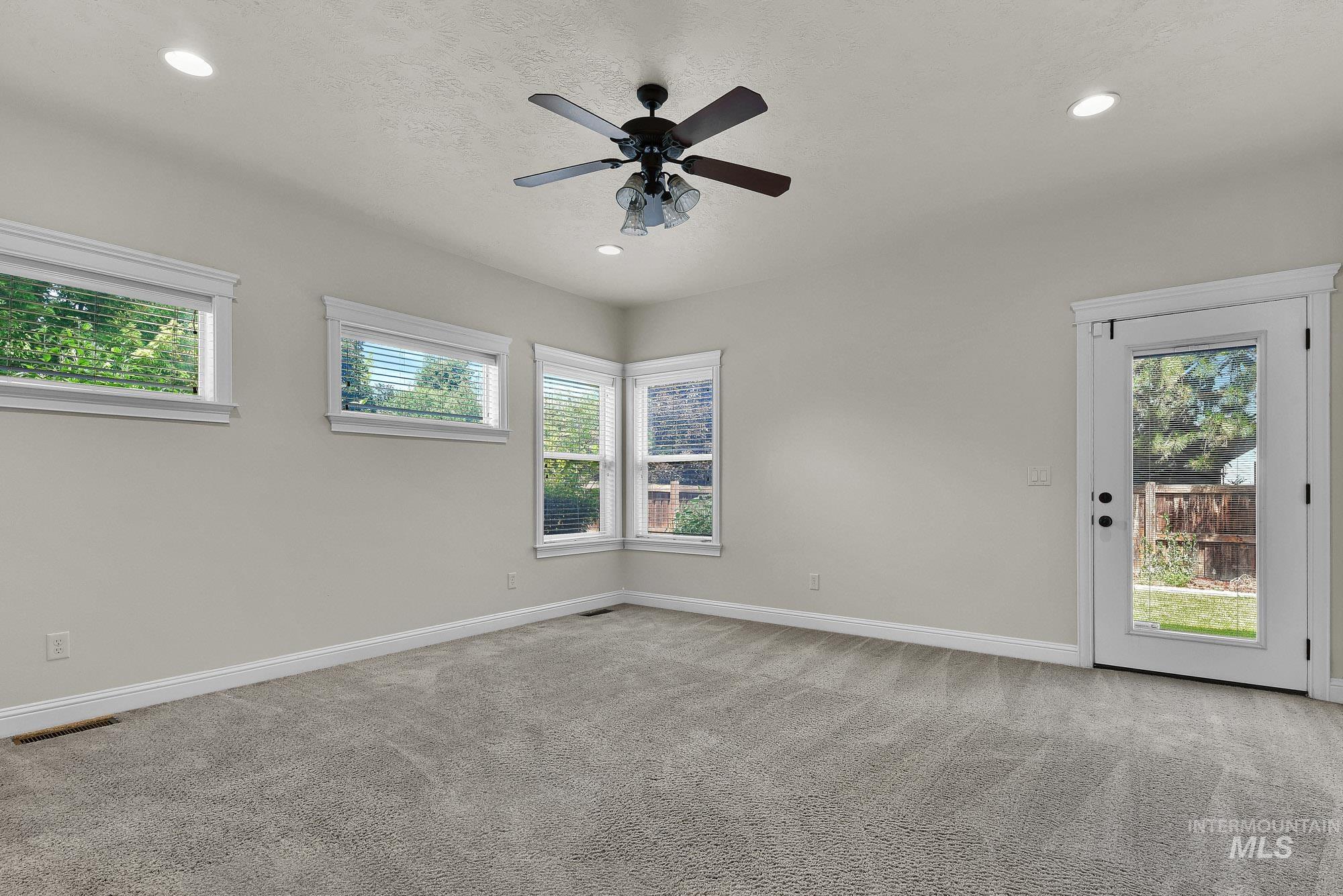 2172 West Cedar Grove Street Meridian, ID 83646 - Photo 13 of 49 Spacious room featuring light-colored walls, recessed lighting, and a ceiling fan with light fixture