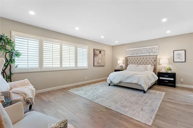 a bedroom with a large bed and a couch