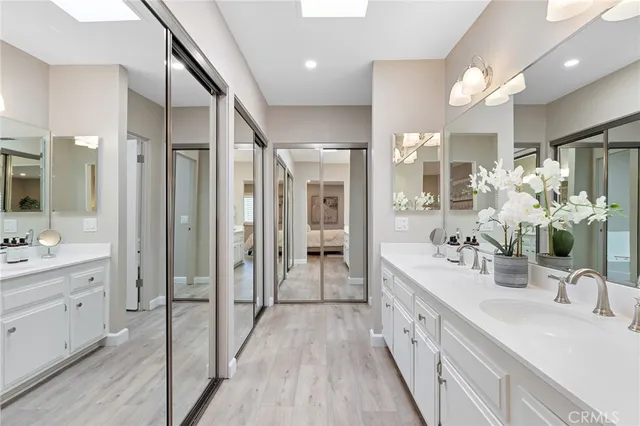 a bathroom with a double vanity sink mirror and shower
