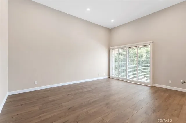 a view of wooden floor and windows in a room