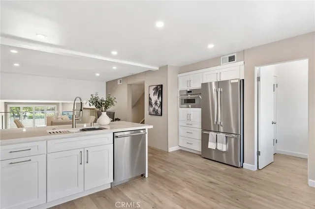 a kitchen with a refrigerator and a sink