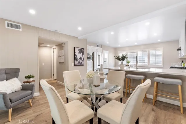 a dining room with furniture and wooden floor