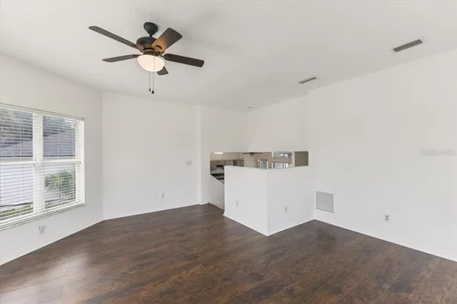 a view of a kitchen with wooden floor and window
