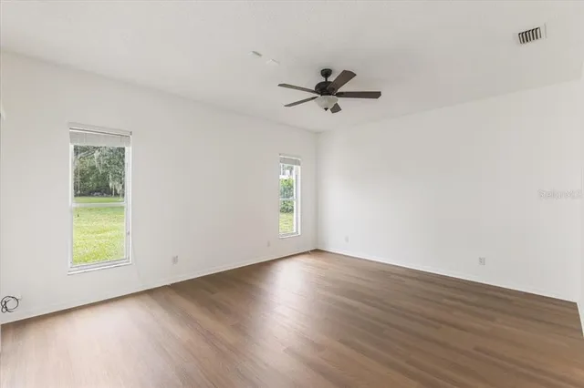 a view of room with hardwood floor and window
