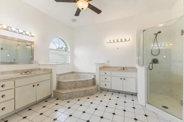 a bathroom with a sink a toilet a mirror and shower