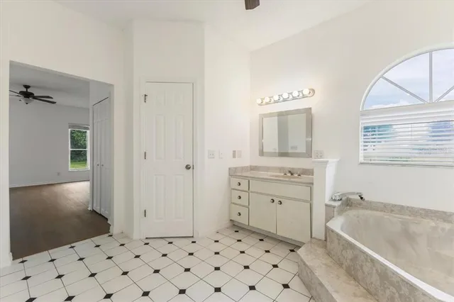 a bath room with a sink a vanity and a mirror