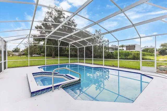 a view of a backyard with swimming pool
