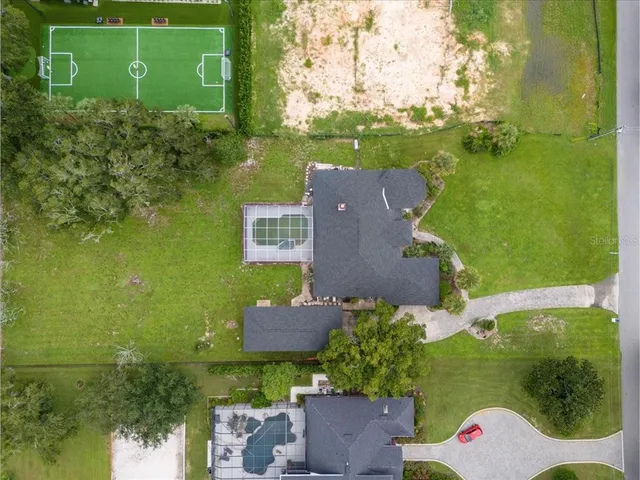 an aerial view of a house with a yard