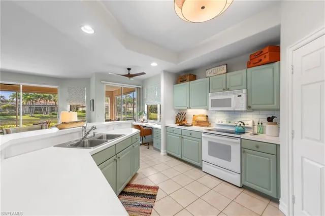 a kitchen with stainless steel appliances granite countertop a sink and a stove