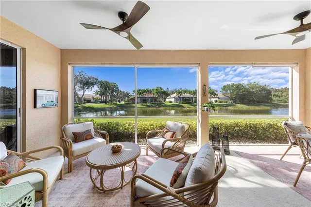 a living room with furniture and a floor to ceiling window