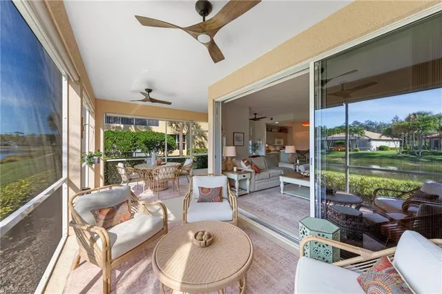 a view of a patio with couches chairs and a floor to ceiling window