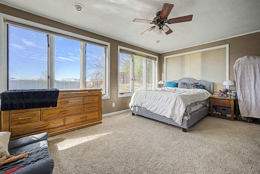 2014 East 9th Street Craig, CO 81625 - Photo 12 of 29 a bedroom with a bed dresser and a window