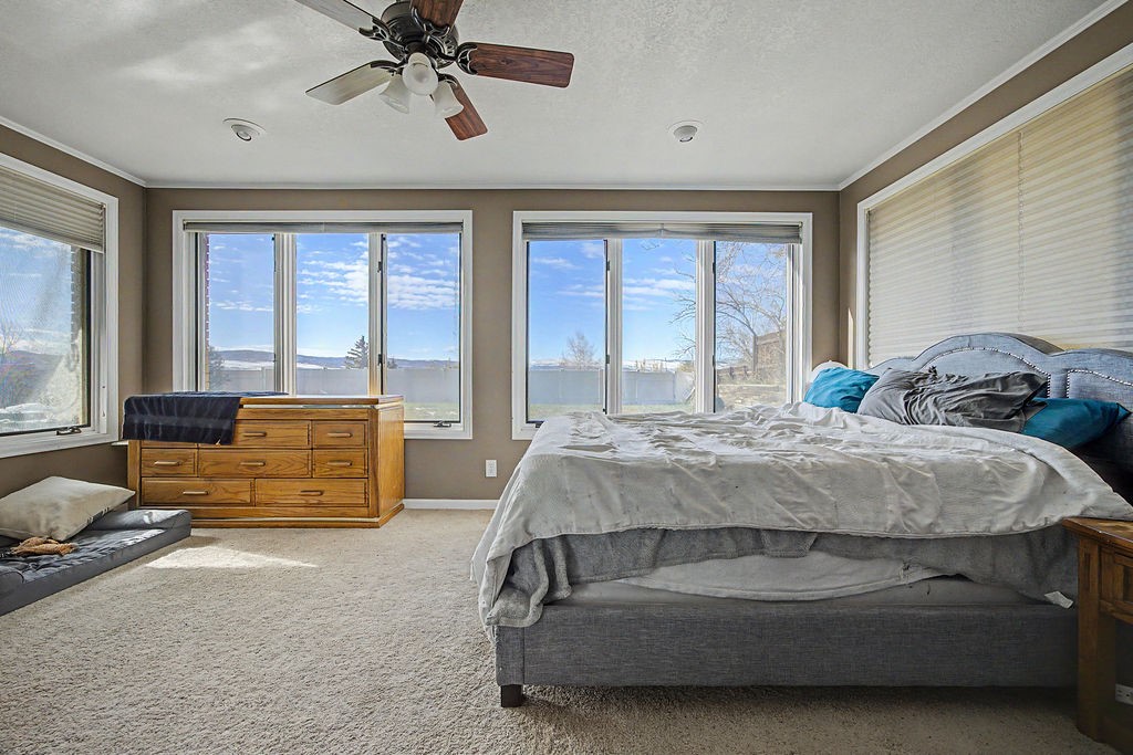 2014 East 9th Street Craig, CO 81625 - Photo 13 of 29 a bedroom with a bed and couch