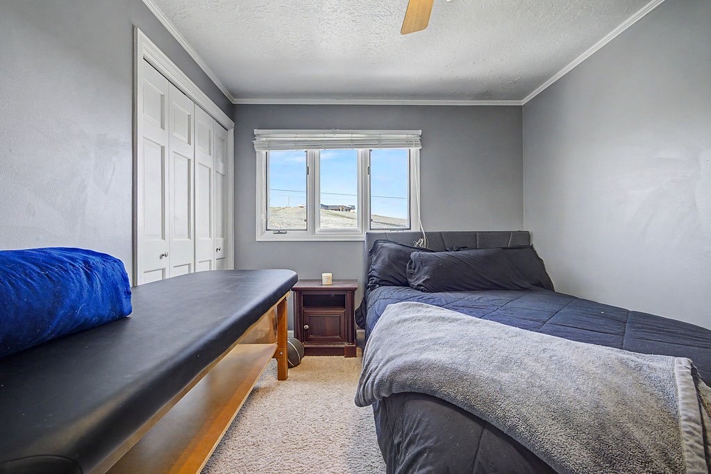2014 East 9th Street Craig, CO 81625 - Photo 16 of 29 a bed sitting in a bedroom next to a window
