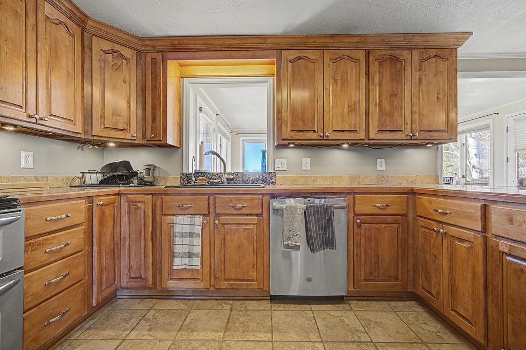 2014 East 9th Street Craig, CO 81625 - Photo 2 of 29 a kitchen with stainless steel appliances granite countertop a sink and cabinets