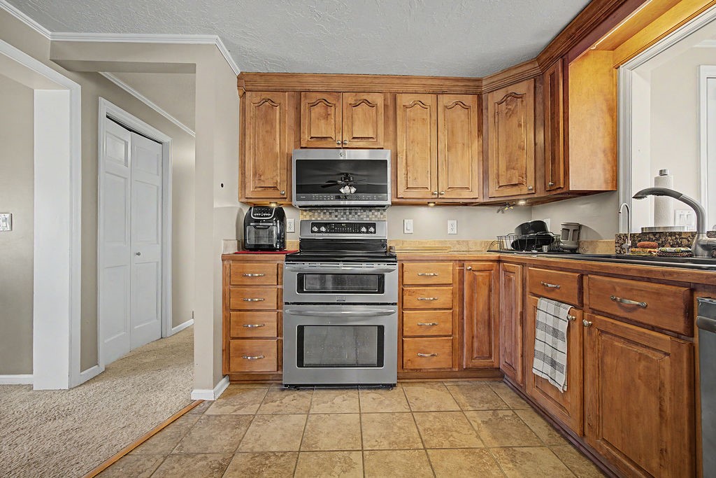 2014 East 9th Street Craig, CO 81625 - Photo 3 of 29 a kitchen with a stove top oven and cabinets