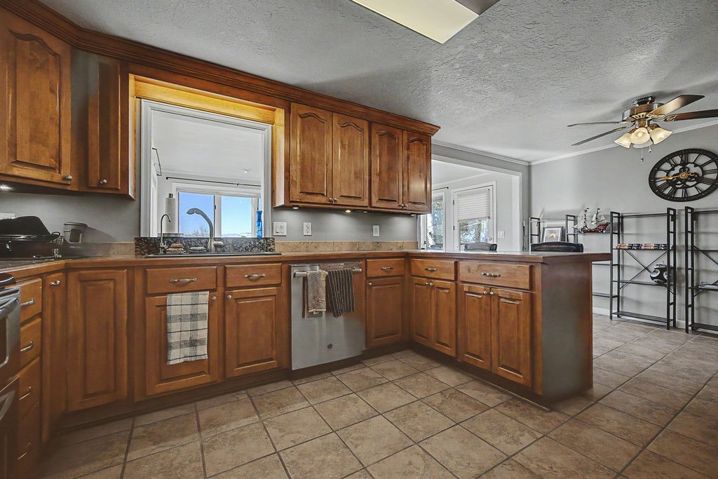 2014 East 9th Street Craig, CO 81625 - Photo 4 of 29 a kitchen with stainless steel appliances granite countertop a stove sink and cabinets