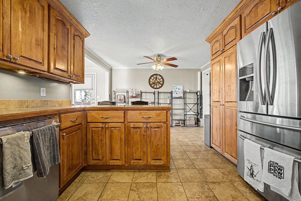 2014 East 9th Street Craig, CO 81625 - Photo 5 of 29 a kitchen with stainless steel appliances granite countertop a refrigerator a stove and a sink