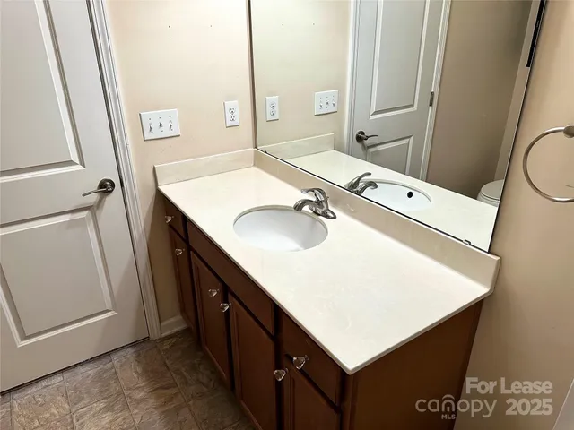 a bathroom with a sink vanity and a mirror