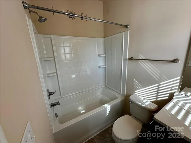 a bathroom with a shower and toilet