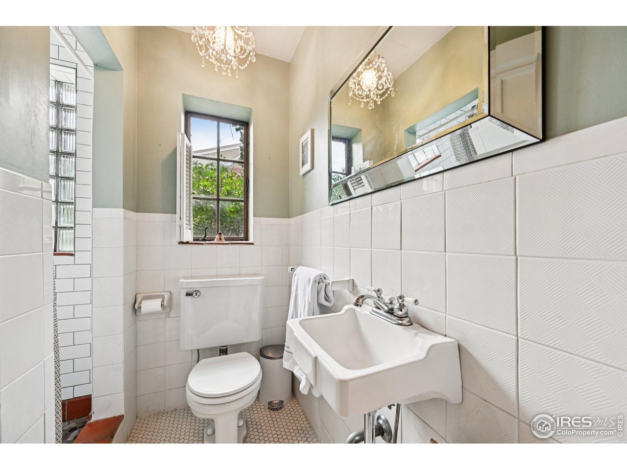 715 14th Street Boulder, CO 80302 - Photo 19 of 43 a bathroom with a sink a toilet and a mirror