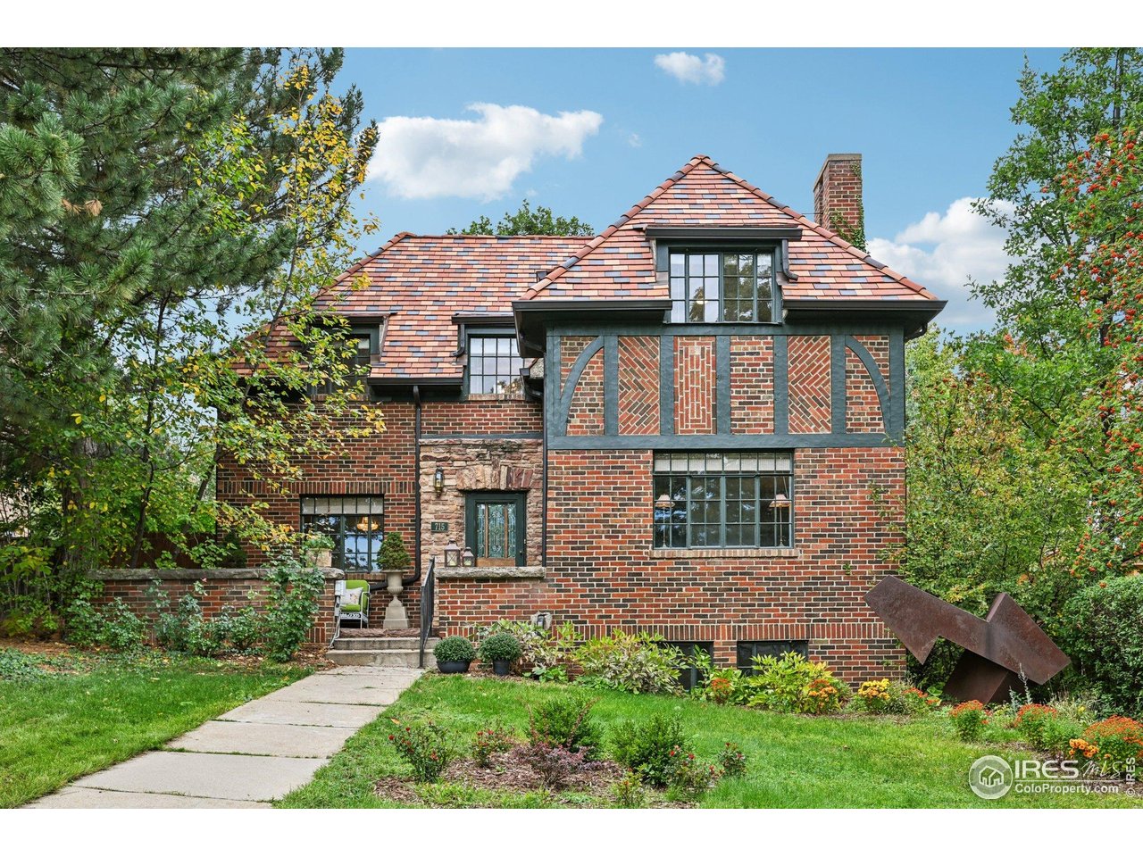 715 14th Street Boulder, CO 80302 - Photo 2 of 43 a front view of a house with a garden