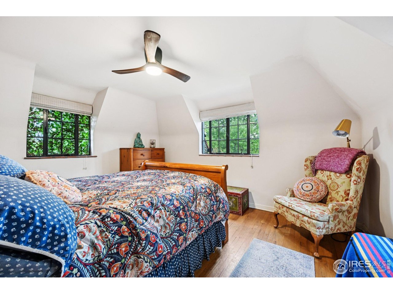 715 14th Street Boulder, CO 80302 - Photo 22 of 43 a bedroom with a bed and a chandelier