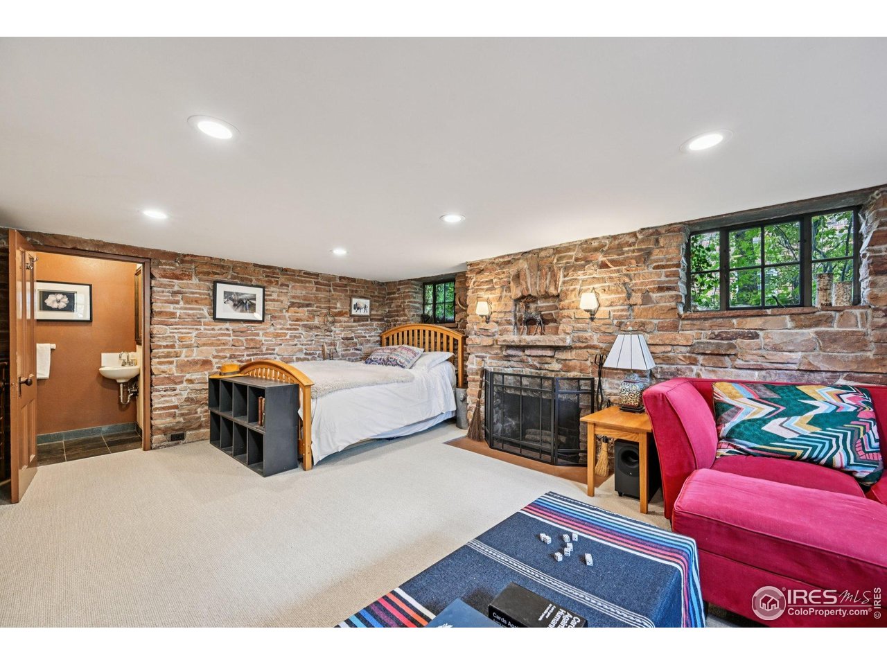 715 14th Street Boulder, CO 80302 - Photo 28 of 43 a living room with furniture a fireplace and a flat screen tv