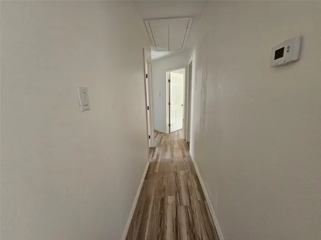 a view of a room with wooden floor