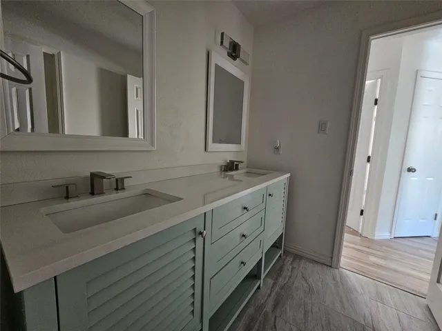 a bathroom with a double vanity sink and mirror