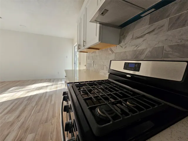 a stove top oven sitting inside of a kitchen