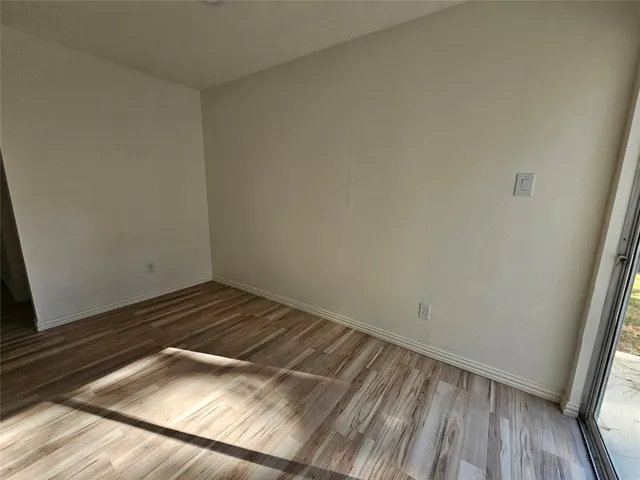 a view of a room with wooden floor