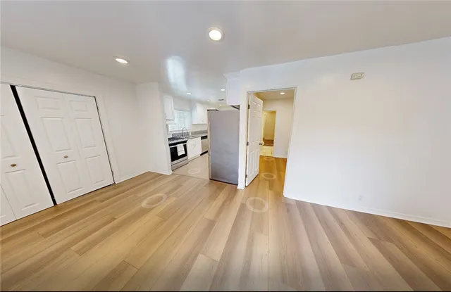 a view of a hallway with wooden floor