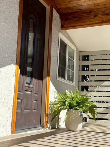 a white house with potted plants in front of it