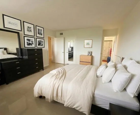 a bedroom with a bed and a night stand