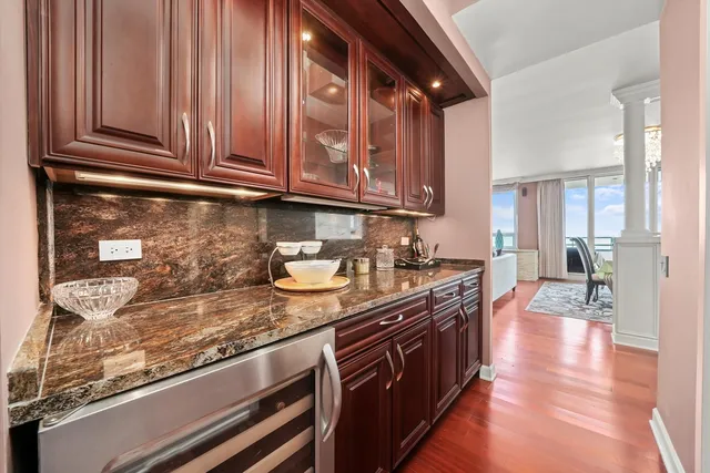 a kitchen with stainless steel appliances granite countertop a sink stove and cabinets
