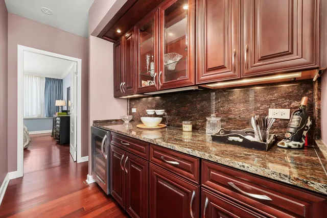a kitchen with granite countertop stainless steel appliances a sink and cabinets