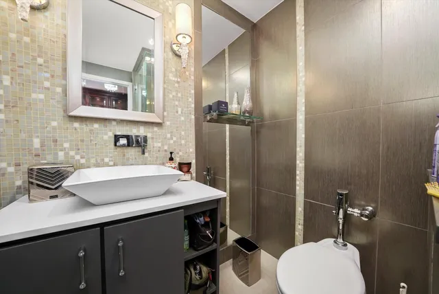 a bathroom with a sink toilet and shower