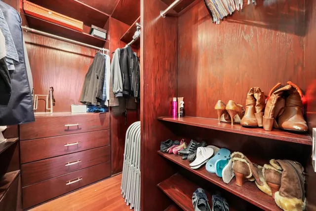 a room with a baby crib and a dresser