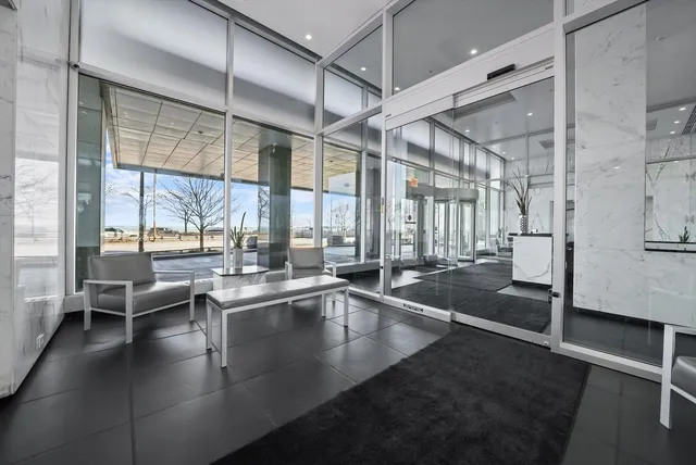 a kitchen with a large window and chairs