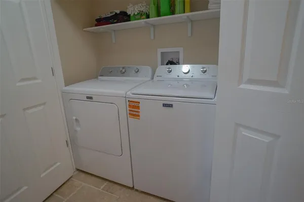 a bathroom with a double vanity sink a toilet and a bathtub