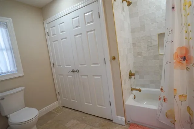 a bed room with a bed furniture and a flat screen tv