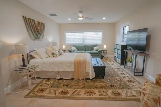 a bedroom with a bed and a table chair